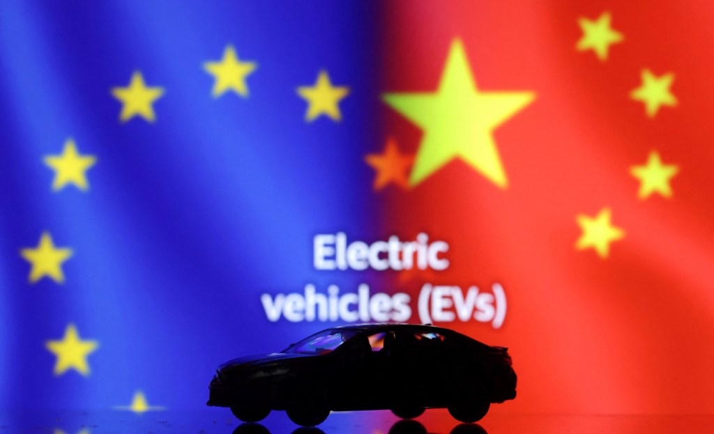 Illustration shows Car miniature, “Electric vechicles (EVs)” words, EU and Chinese&nbsp;flags